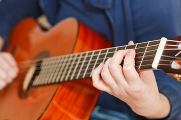 Fototapeta premium girl plays on classical acoustic guitar