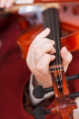 girl playing fiddle - chord on fingerboard
