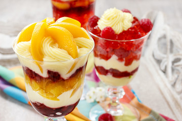 Layer fruit desserts on wooden tray. Summer garden party