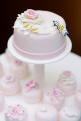 Delicious pink wedding cake and cupcakes