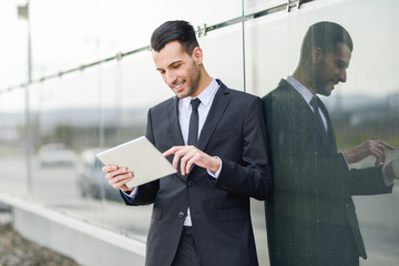 Businessman with tablet computer in office building