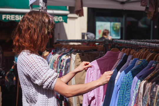Woman browsing clothes at market