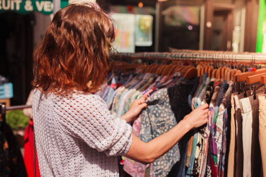 Woman browsing clothes at market