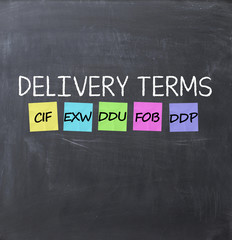 Delivery terms with adhesive notes on a blackboard