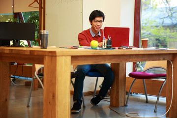 Young asian man using laptop