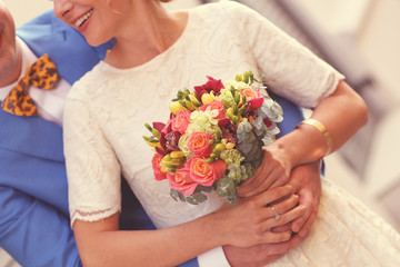 Obraz na płótnie Canvas bride holding wedding flowers bouquet