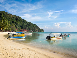 Fototapeta na wymiar Boats in Coral Bay beach, Pulau Perhentian, Malaysia