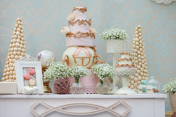 Elegant sweet table with big cake and macaroon