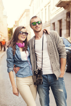 Happy hipster couple in city