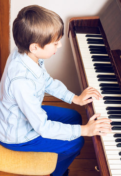 Beautiful little child playing piano