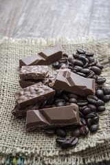 chocolate bars and coffee beans  on wooden table