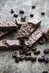 chocolate bars and coffee beans  on wooden table