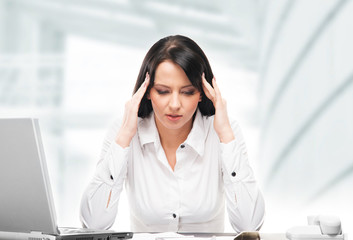Young and attractive business woman working in office isolated