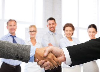 businessman and businesswoman shaking hands