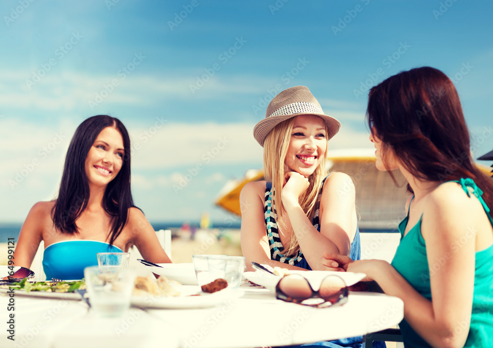 Poster girls in cafe on the beach