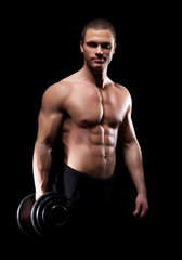 Fototapeta na wymiar Strong, fit and sporty bodybuilder man with a dumbbell