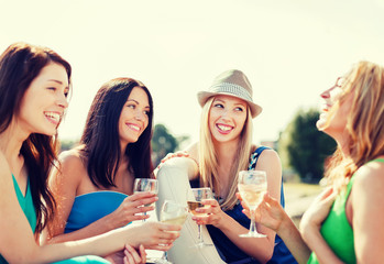 Fototapeta na wymiar girls with champagne glasses on boat