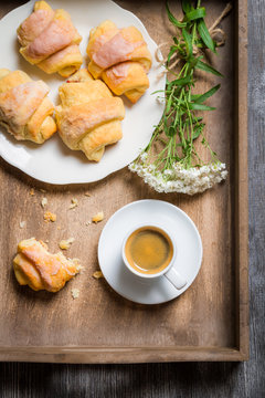Breakfast in bed with a croissant and flowers