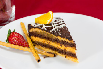 Chocolate cake slice isolated on white plate
