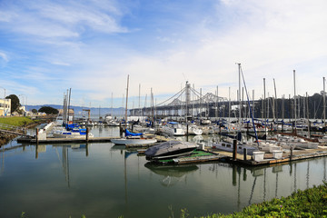 Fototapeta na wymiar Boats and San Francisco Oakland bay bridge