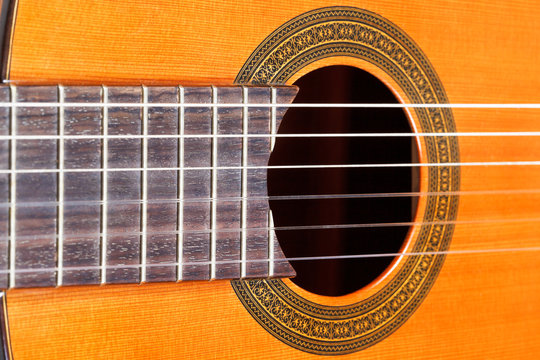 fingerboard and sound hole of acoustic guitar