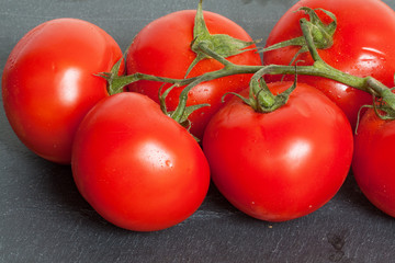 Tomates en grappe sur fond d'ardoise