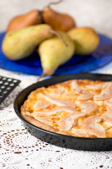 Pizza pere e brie nella teglia sul tavolo