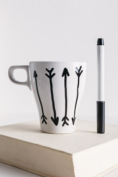 White coffee mug with arrows.