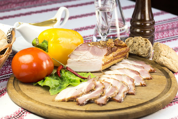 bacon on the table in a restaurant with sauce and vegetables