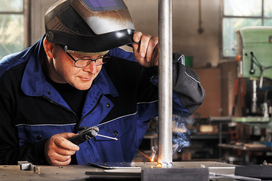 Welder With Protective Face Mask At Work