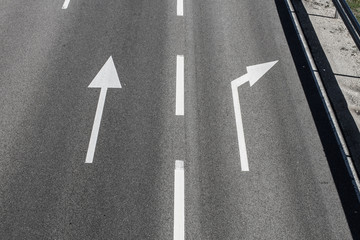 arrows on asphalt showing traffic where to go