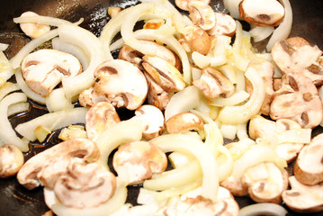 Portabella Mushrooms and Sweet Onions Frying in a Pan