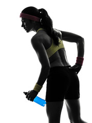 Fototapeta na wymiar woman exercising fitness holding energy drink silhouette