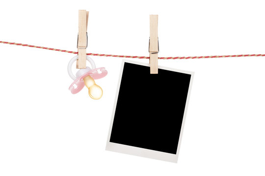Instant photo and pacifier hanging on the clothesline
