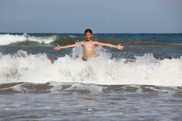 boy play with ocean waves