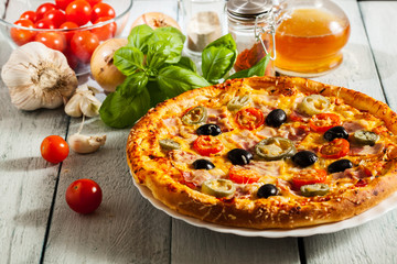 Pizza with bacon, olives and jalapeno pepper