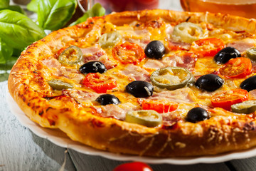 Pizza with bacon, olives and jalapeno pepper