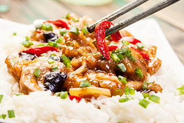 Sirloins on sweet and sour sauce served with rice