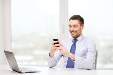 businessman with laptop and smartphone at office