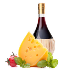 Red wine bottle, cheese and tomato still life