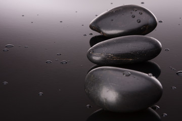 Spa stone arrangement on black surface. Healthcare concept.