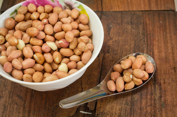 Peanuts in bowl and spoon