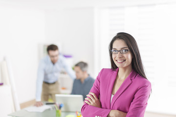 Portrait of a smiling businesswoman in meeting