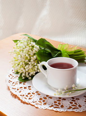 morning tea table setting with Lily of the valley flowers bouqet