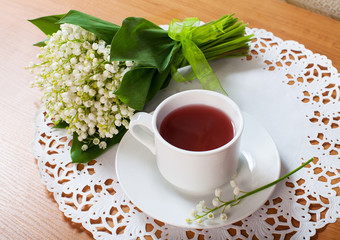morning tea table setting with Lily of the valley flowers bouqet