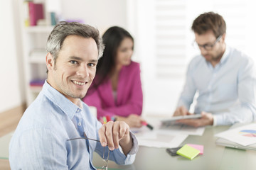 Portrait of a smiling senior businessman  in meeting