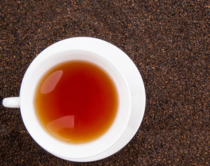 A cup of tea on dried and processed tea leaves
