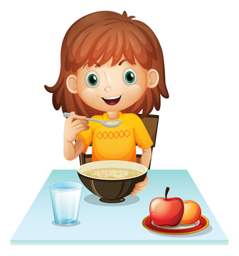 A little girl eating her breakfast