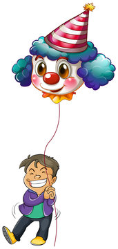A happy boy holding a clown balloon