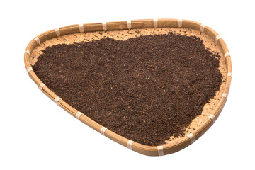 Dried and processed tea leaves in a wicker tray